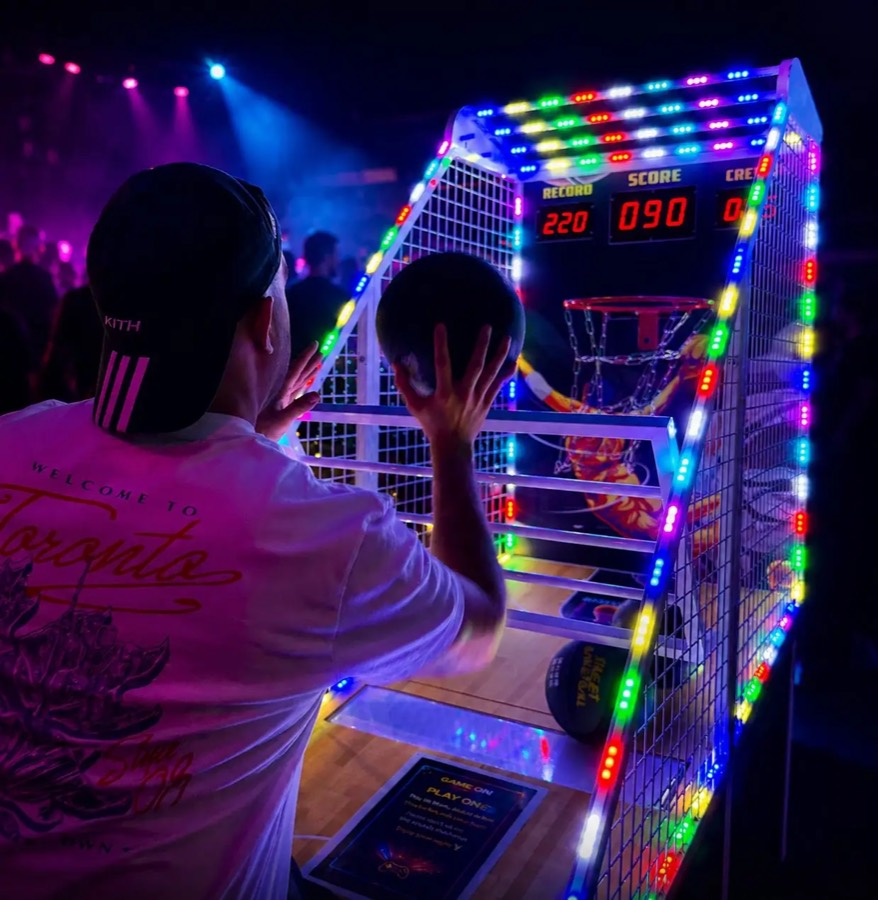 Power Hoops arcade basketball machine in play in a busy venue